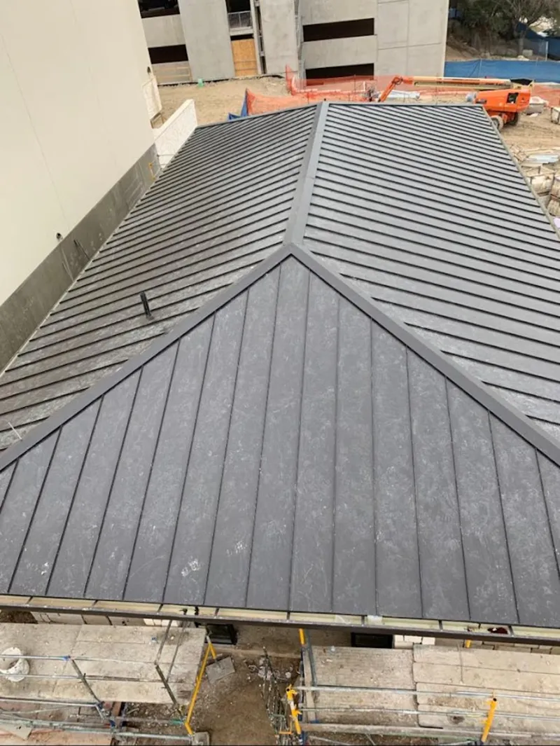 Commercial metal roof construction with crane equipment in White Settlement